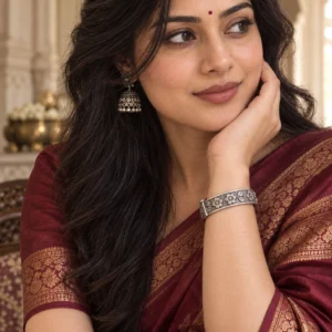 Oxidised silver-plated flower kada worn with a wine silk saree