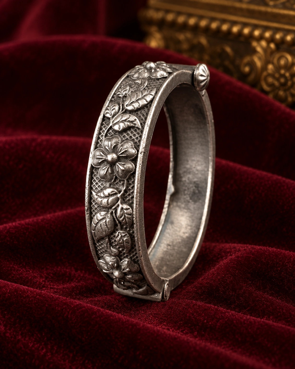 Openable oxidised flower kada displayed on royal burgundy velvet