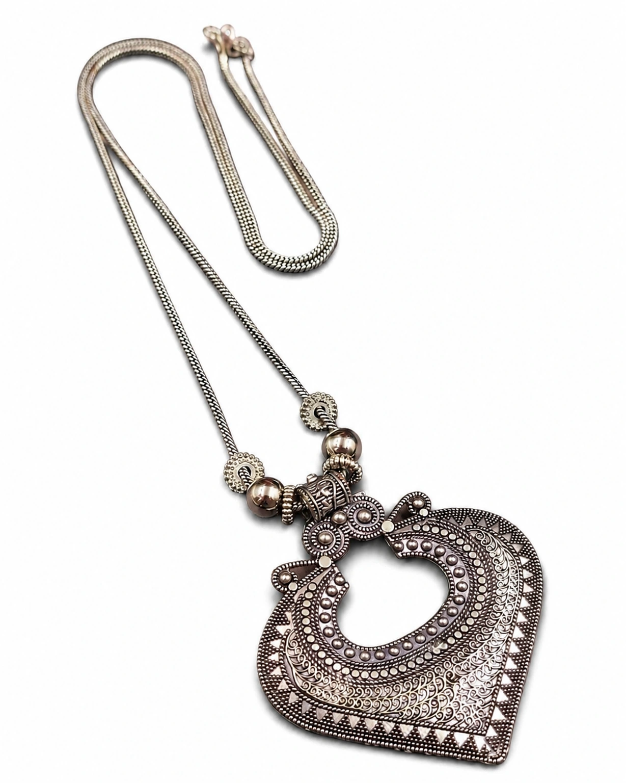 Oxidized silver necklace isolated on a pure white ecommerce background.