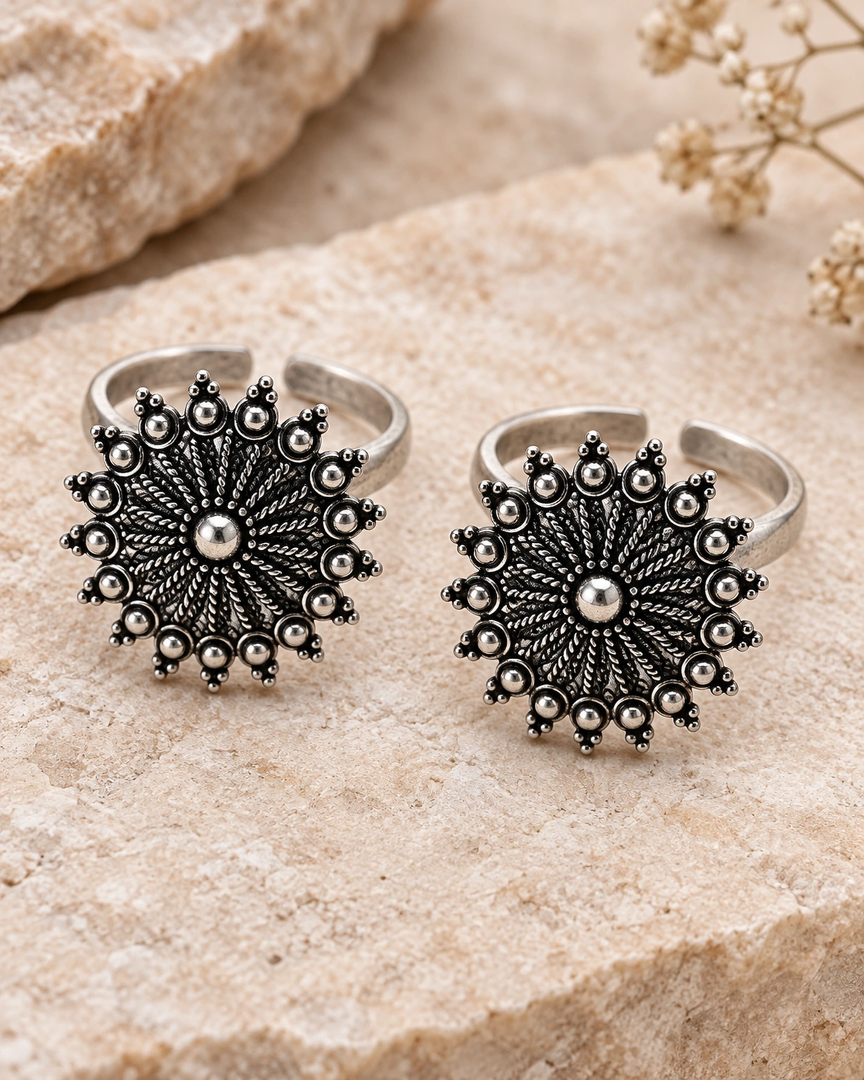 Close-up of sunburst floral bichiya with adjustable silver bands